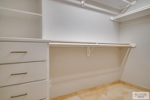 spacious closet featuring tile patterned floors