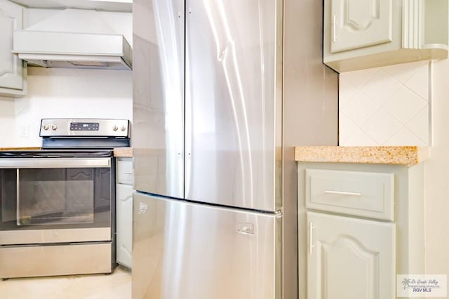 kitchen with custom range hood, stainless steel appliances, and tasteful backsplash