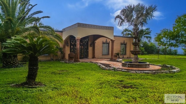 171 Line 17 Rd, San Benito, TX 78586 - rear view of property with a yard and stucco siding
