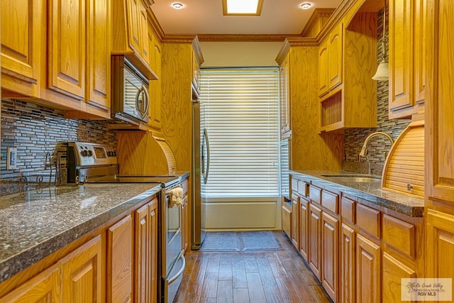 171 Line 17 Rd, San Benito, TX 78586 - kitchen with appliances with stainless steel finishes, dark wood-type flooring, decorative backsplash, brown cabinets, and crown molding