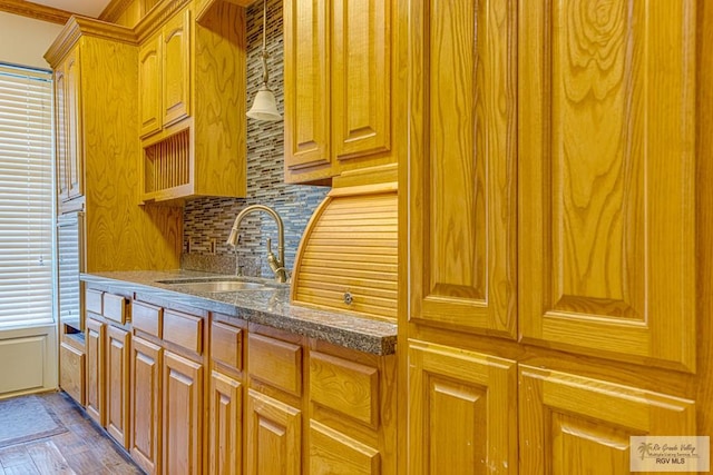 171 Line 17 Rd, San Benito, TX 78586 - kitchen with tasteful backsplash, dark stone countertops, brown cabinets, and dark wood-style flooring
