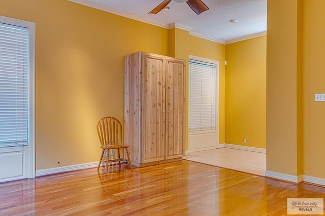 171 Line 17 Rd, San Benito, TX 78586 - empty room featuring wood finished floors, a ceiling fan, ornamental molding, and a smoke detector