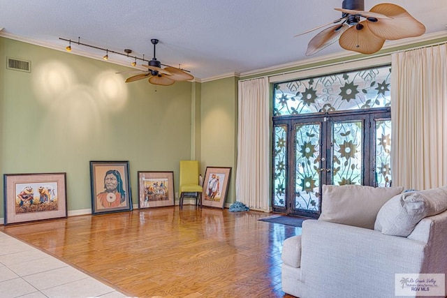 171 Line 17 Rd, San Benito, TX 78586 - living area with a ceiling fan, crown molding, track lighting, wood finished floors, and a textured ceiling