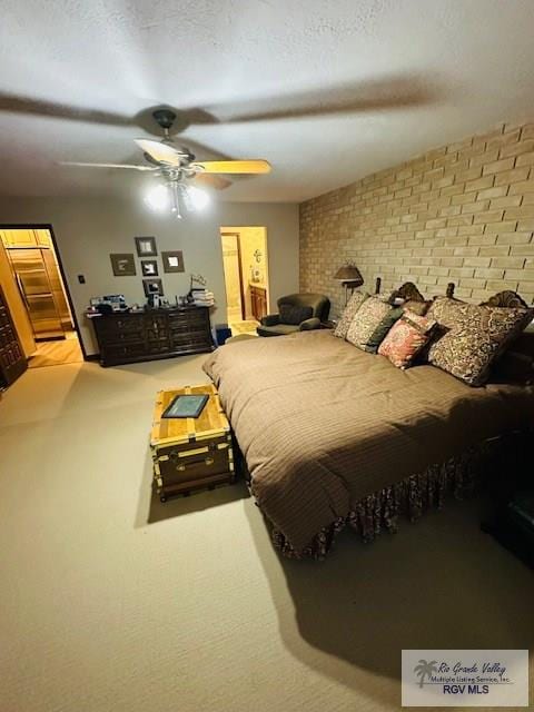 carpeted bedroom featuring brick wall and ceiling fan