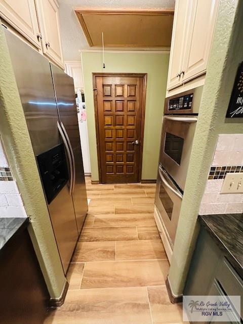 kitchen with white cabinetry, appliances with stainless steel finishes, and light hardwood / wood-style flooring