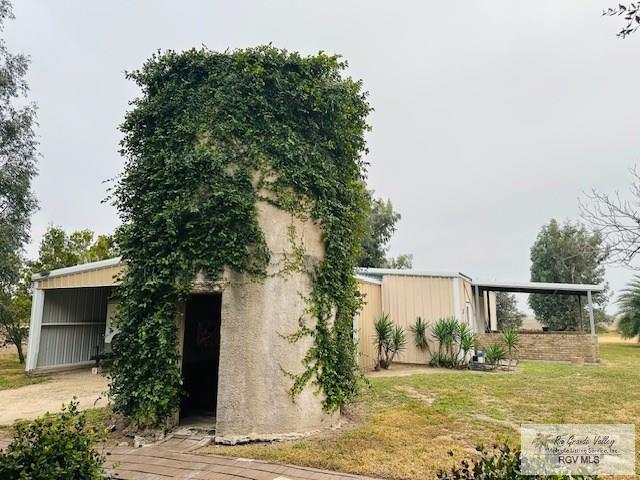 view of side of home featuring a yard