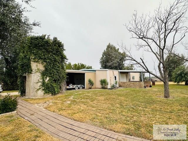 view of front of house with a front yard and a carport