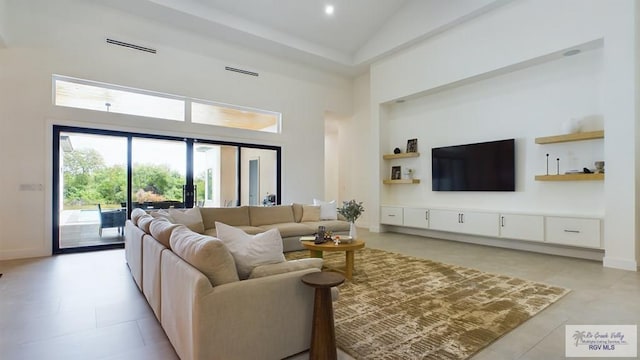 60 Jacklyn St, Rancho Viejo, TX 78575 - living room featuring light tile patterned floors and high vaulted ceiling