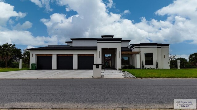 view of front of property with a front yard and a garage