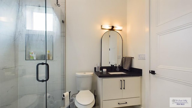 60 Jacklyn St, Rancho Viejo, TX 78575 - bathroom featuring vanity, toilet, and a shower with door