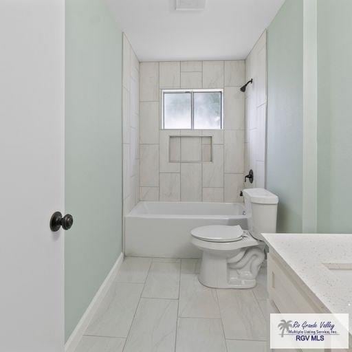 full bathroom with vanity, toilet, and tiled shower / bath combo