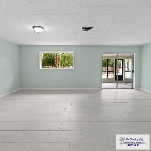 1802 High St, Harlingen, TX 78550 - tiled empty room with a wealth of natural light