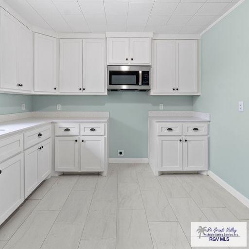 1802 High St, Harlingen, TX 78550 - kitchen featuring white cabinets