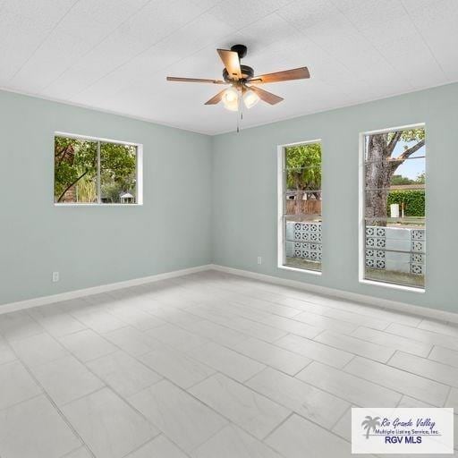 1802 High St, Harlingen, TX 78550 - spare room with ceiling fan and a healthy amount of sunlight