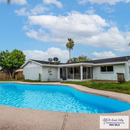 view of pool featuring a sunroom