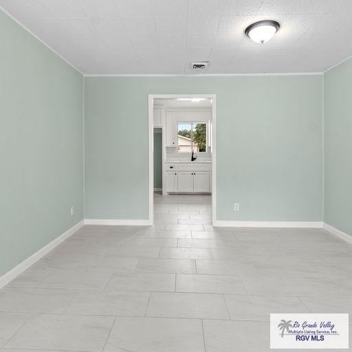 unfurnished room featuring ornamental molding