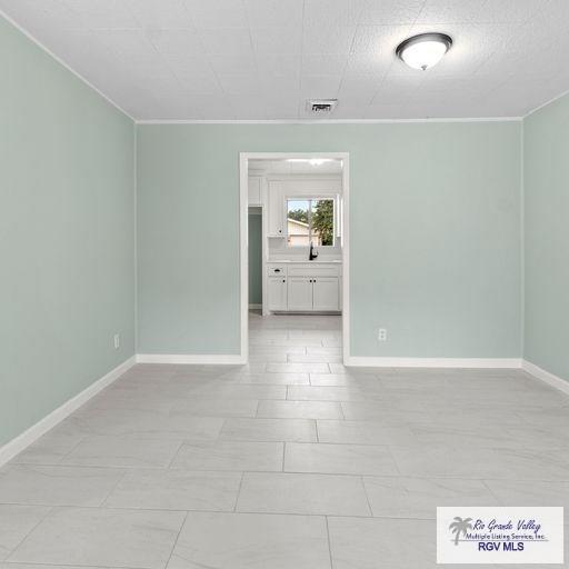 1802 High St, Harlingen, TX 78550 - unfurnished room featuring ornamental molding