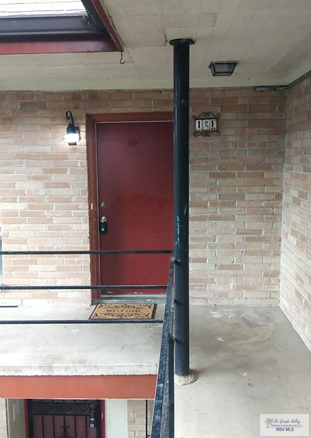 property entrance featuring brick siding