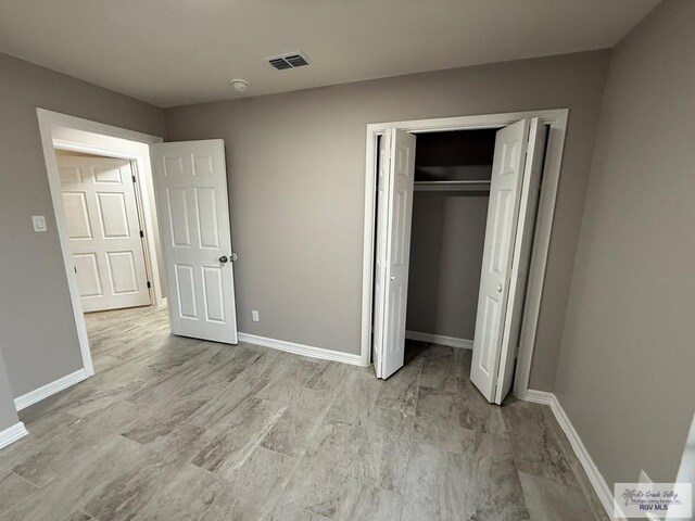 902 Rio Hondo Rd, Harlingen, TX 78550 - unfurnished bedroom with baseboards and a closet