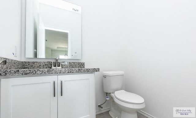 33521 Stanford Rd, Los Fresnos, TX 78566 - bathroom with baseboards, toilet, and vanity