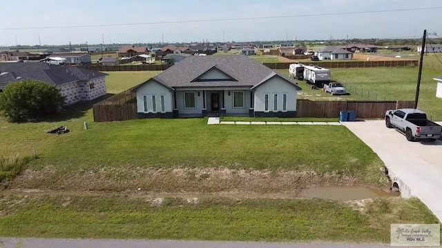 33521 Stanford Rd, Los Fresnos, TX 78566 - view of front of home with a residential view, a shingled roof, and stucco siding