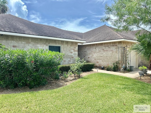 view of property exterior with a lawn