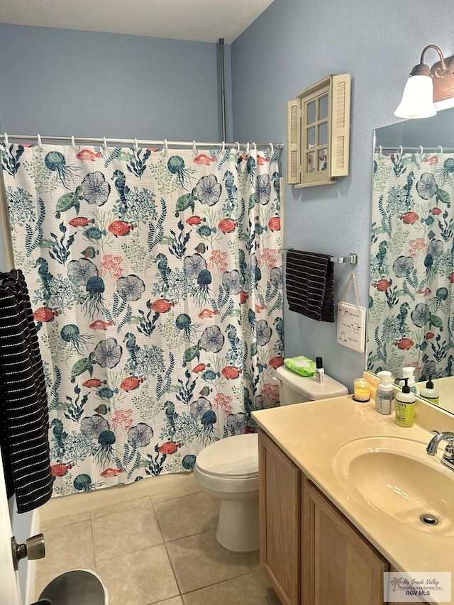 bathroom featuring tile patterned floors, vanity, and toilet