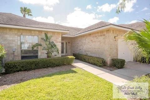 entrance to property with a yard and a garage