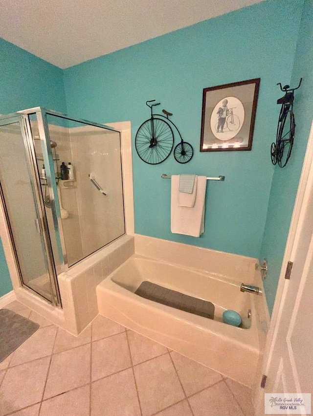 bathroom featuring tile patterned floors, shower with separate bathtub, and a textured ceiling