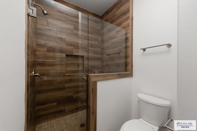 bathroom featuring toilet and walk in shower