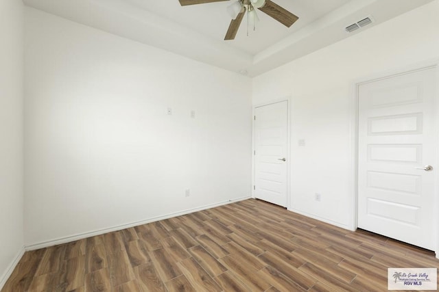 unfurnished bedroom featuring dark hardwood / wood-style flooring and ceiling fan