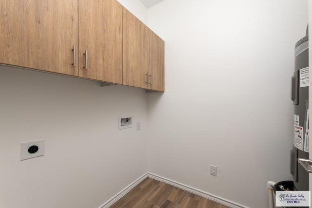 washroom featuring hookup for an electric dryer, dark hardwood / wood-style flooring, cabinets, and washer hookup