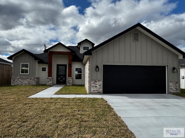 view of front of property featuring a garage and a front lawn