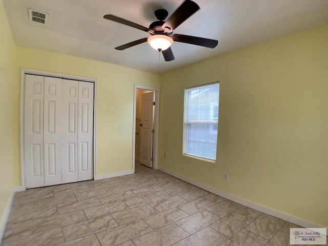 205 W Beck Ave, Harlingen, TX 78550 - unfurnished bedroom with a closet, a ceiling fan, and light marble finish flooring