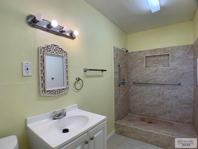 205 W Beck Ave, Harlingen, TX 78550 - full bathroom featuring vanity, tiled shower, and tile patterned flooring