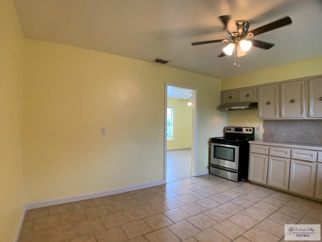205 W Beck Ave, Harlingen, TX 78550 - kitchen with stainless steel electric range, a ceiling fan, under cabinet range hood, light countertops, and tasteful backsplash