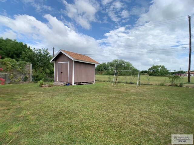 205 W Beck Ave, Harlingen, TX 78550 - fenced backyard with a storage shed and a playground