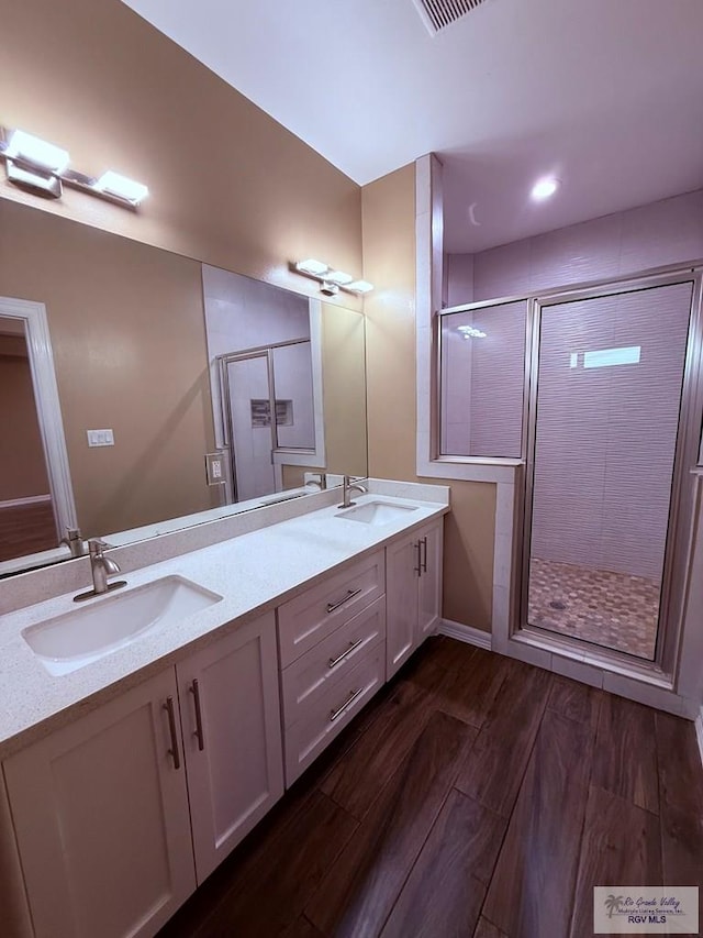 bathroom with vanity, hardwood / wood-style floors, and an enclosed shower