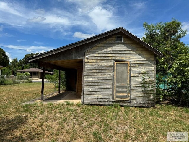 view of outbuilding with a yard