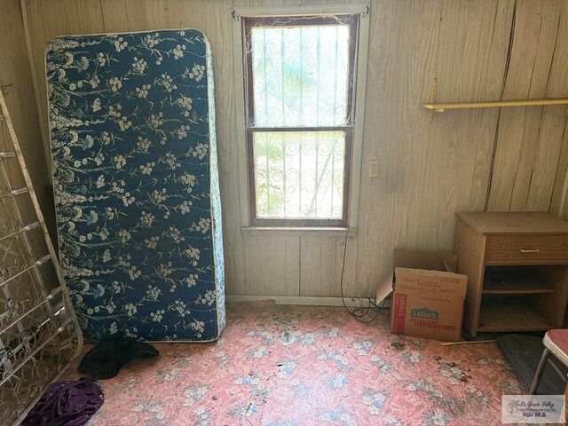 2044 E Jackson St, Brownsville, TX 78520 - bedroom with multiple windows, wooden walls, and baseboards