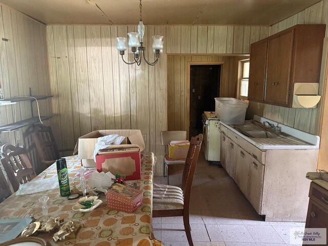 2044 E Jackson St, Brownsville, TX 78520 - dining room featuring wood walls and a chandelier