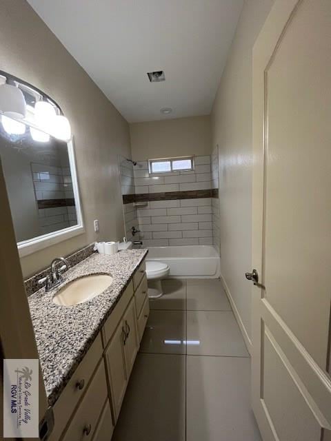 full bathroom featuring tile patterned floors, tiled shower / bath, vanity, and toilet