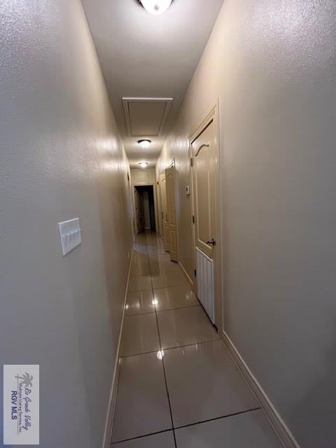 hall featuring light tile patterned flooring