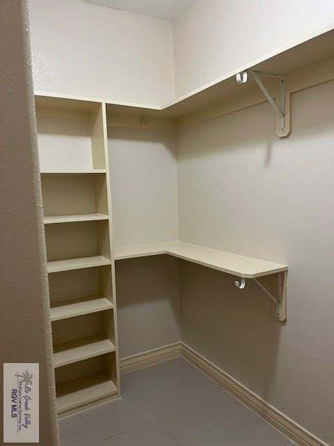 spacious closet featuring tile patterned floors