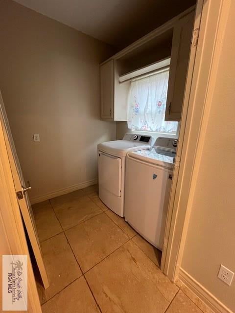 laundry room featuring cabinets, separate washer and dryer, and light tile patterned floors