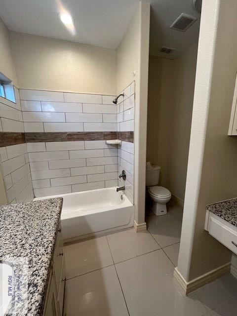 full bathroom featuring tile patterned flooring, vanity, toilet, and washtub / shower combination