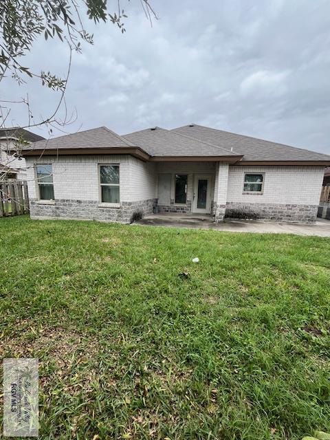 rear view of property with a patio area and a yard