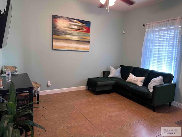 living room featuring tile patterned floors and ceiling fan