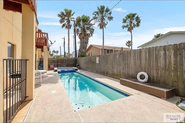 view of swimming pool featuring a patio area