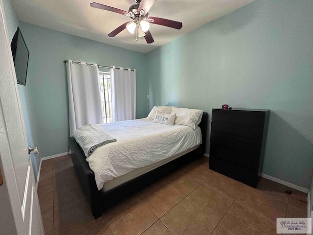 bedroom with tile patterned flooring and ceiling fan